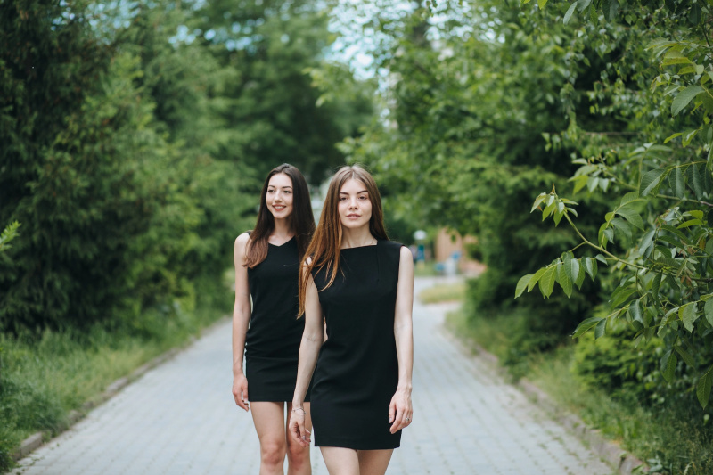   Duas-Mulheres-Jovens-Em-Pequenos-Vestidos-Pretos-Estoque-Foto